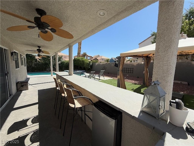 9485 Supernova Ct, Las Vegas, NV 89123 - fenced backyard with a gazebo, a pool with connected hot tub, and ceiling fan