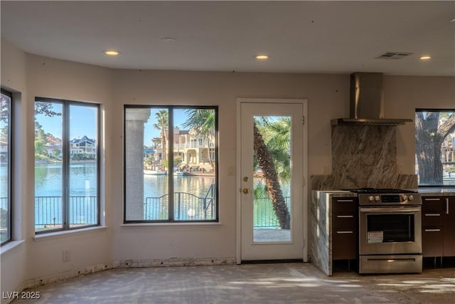 8740 Captains Pl, Las Vegas, NV 89117 - kitchen with wall chimney range hood, stainless steel gas range, plenty of natural light, and recessed lighting