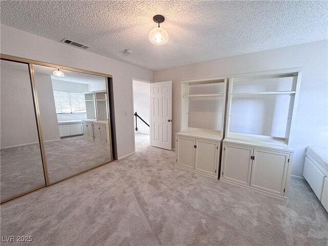 8740 Captains Pl, Las Vegas, NV 89117 - unfurnished bedroom with light carpet and a textured ceiling