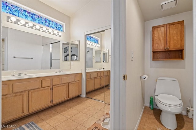 5317 Marietta Ave, Las Vegas, NV 89108 - bathroom featuring tile patterned flooring, double vanity, baseboards, and toilet
