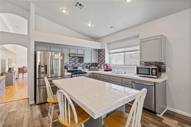 5317 Marietta Ave, Las Vegas, NV 89108 - kitchen with stainless steel appliances, gray cabinets, tile countertops, a sink, and tasteful backsplash