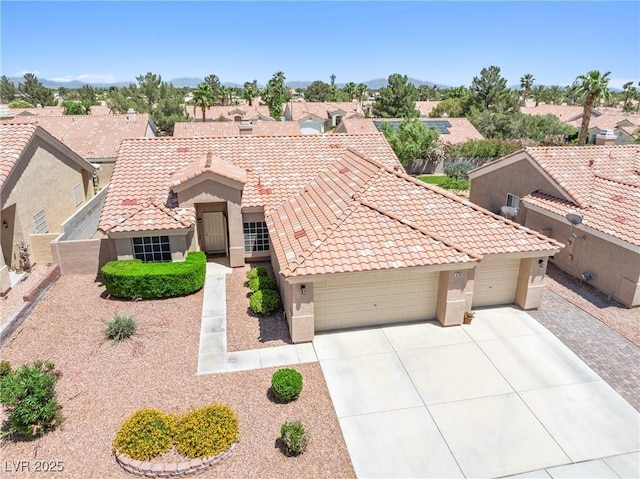 5704 Owl Butte Ct, Las Vegas, NV 89149 - mediterranean / spanish home with stucco siding, a garage, driveway, a tile roof, and a residential view