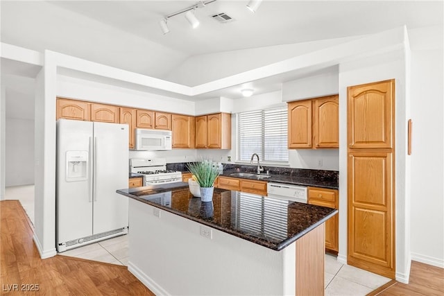 5704 Owl Butte Ct, Las Vegas, NV 89149 - kitchen with white appliances, a sink, track lighting, lofted ceiling, and dark stone counters