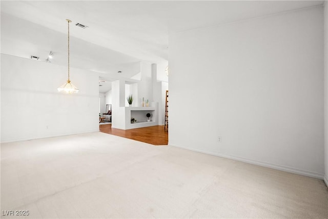 5704 Owl Butte Ct, Las Vegas, NV 89149 - unfurnished living room featuring carpet floors, lofted ceiling, and baseboards