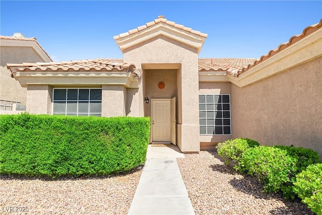 5704 Owl Butte Ct, Las Vegas, NV 89149 - doorway to property with stucco siding and a tiled roof