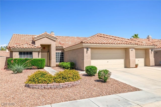5704 Owl Butte Ct, Las Vegas, NV 89149 - view of front facade with stucco siding, an attached garage, a tiled roof, and concrete driveway