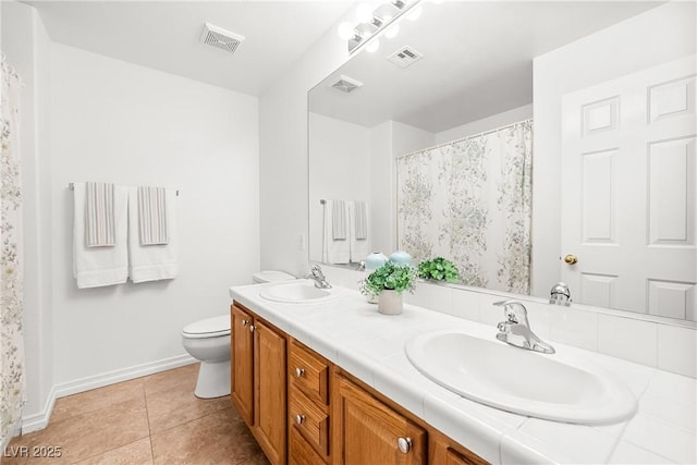 5704 Owl Butte Ct, Las Vegas, NV 89149 - full bathroom featuring double vanity, baseboards, toilet, and tile patterned flooring