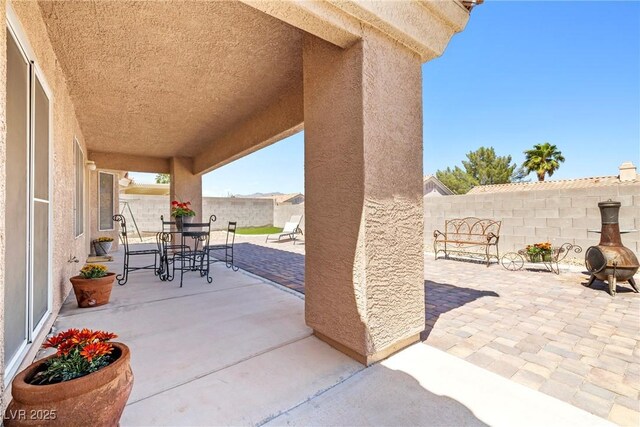 5704 Owl Butte Ct, Las Vegas, NV 89149 - fenced backyard featuring outdoor dining space and a patio