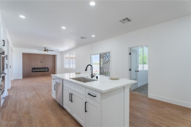 1136 Casady Hollow Ave, Henderson, NV 89012 - kitchen featuring a sink, stainless steel appliances, ceiling fan, a center island with sink, and plenty of natural light