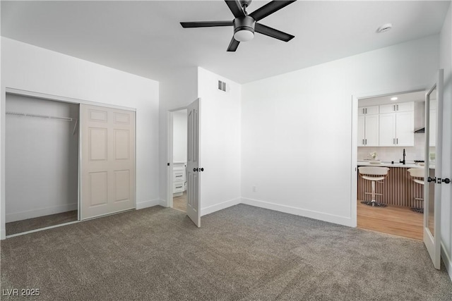 1136 Casady Hollow Ave, Henderson, NV 89012 - unfurnished bedroom featuring carpet floors, a closet, ensuite bath, a ceiling fan, and baseboards