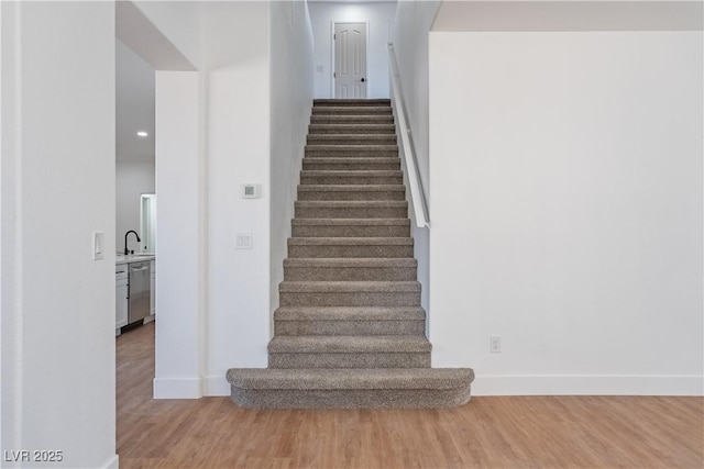 1136 Casady Hollow Ave, Henderson, NV 89012 - stairs featuring baseboards, wood finished floors, and recessed lighting