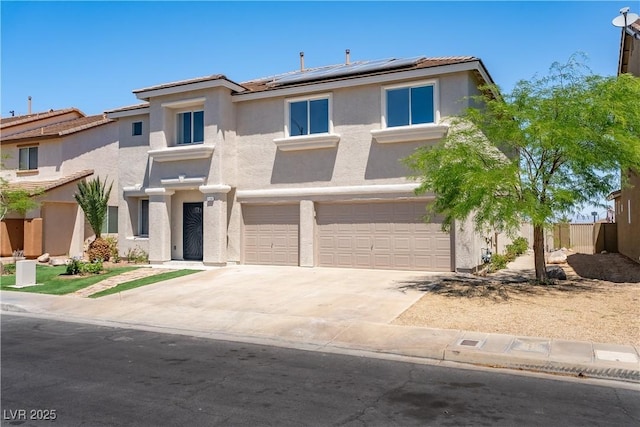 1136 Casady Hollow Ave, Henderson, NV 89012 - view of front of house with stucco siding, a garage, roof mounted solar panels, driveway, and a tiled roof