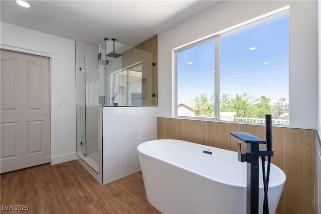 1136 Casady Hollow Ave, Henderson, NV 89012 - bathroom with a stall shower, a freestanding bath, and wood finished floors