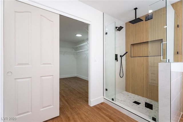 1136 Casady Hollow Ave, Henderson, NV 89012 - full bath featuring a shower stall, wood finished floors, a walk in closet, and baseboards