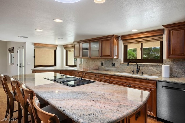8365 S Hauck St, Las Vegas, NV 89139 - kitchen with dishwasher, black electric cooktop, a sink, a center island, and backsplash
