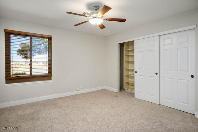 8365 S Hauck St, Las Vegas, NV 89139 - unfurnished bedroom featuring light colored carpet, baseboards, a closet, and a ceiling fan