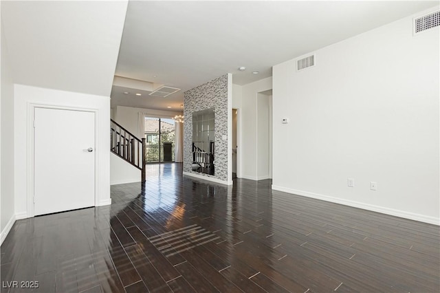 1185 Via Dimartini, Henderson, NV 89052 - unfurnished living room featuring wood finished floors, stairs, baseboards, and a chandelier