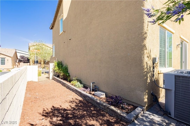 1185 Via Dimartini, Henderson, NV 89052 - view of home's exterior featuring central AC unit and stucco siding