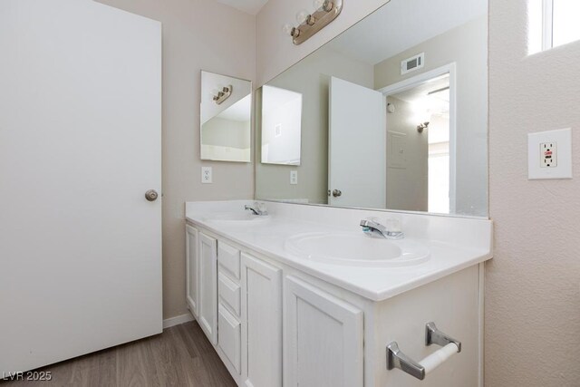 5259 Caspian Springs Dr Unit 203, Las Vegas, NV 89120 - bathroom with double vanity, wood finished floors, and baseboards