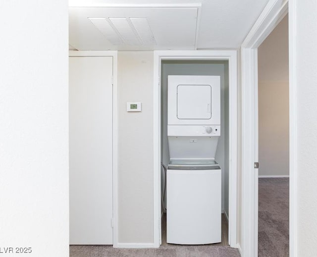 5259 Caspian Springs Dr Unit 203, Las Vegas, NV 89120 - washroom with stacked washing machine and dryer, carpet floors, and baseboards
