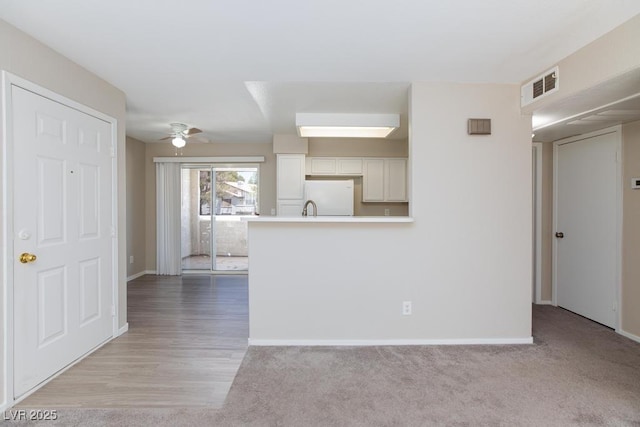 5259 Caspian Springs Dr Unit 203, Las Vegas, NV 89120 - unfurnished living room with ceiling fan, baseboards, a sink, and carpet flooring