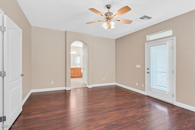 2864 Kinknockie Way, Henderson, NV 89044 - spare room featuring arched walkways, ceiling fan, plenty of natural light, and wood finished floors