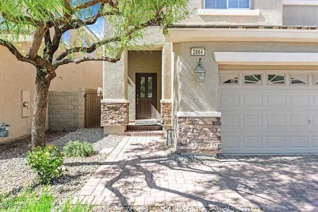 2864 Kinknockie Way, Henderson, NV 89044 - property entrance featuring stone siding, stucco siding, a garage, and driveway