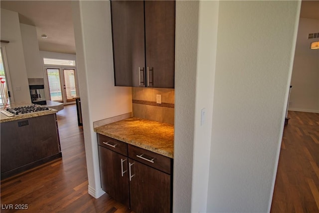 185 Camrose St, Henderson, NV 89074 - kitchen featuring stainless steel gas stovetop, dark brown cabinets, dark wood-style flooring, and baseboards
