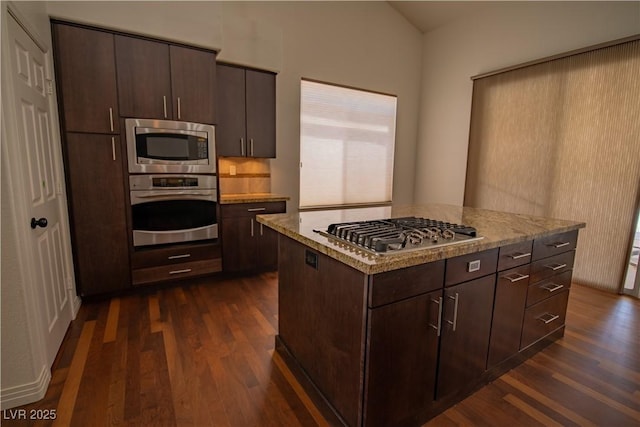 185 Camrose St, Henderson, NV 89074 - kitchen featuring appliances with stainless steel finishes, dark wood-type flooring, dark brown cabinetry, and light stone countertops