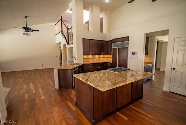 185 Camrose St, Henderson, NV 89074 - kitchen with appliances with stainless steel finishes, a towering ceiling, a sink, a ceiling fan, and dark brown cabinetry