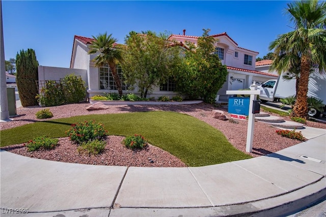 185 Camrose St, Henderson, NV 89074 - mediterranean / spanish-style home with a tiled roof, stucco siding, and a front lawn