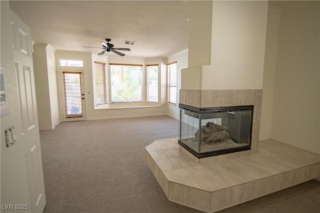 185 Camrose St, Henderson, NV 89074 - unfurnished living room featuring carpet flooring, ceiling fan, baseboards, a multi sided fireplace, and ornamental molding