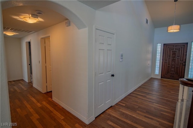 185 Camrose St, Henderson, NV 89074 - foyer entrance featuring arched walkways, dark wood-style floors, baseboards, and vaulted ceiling
