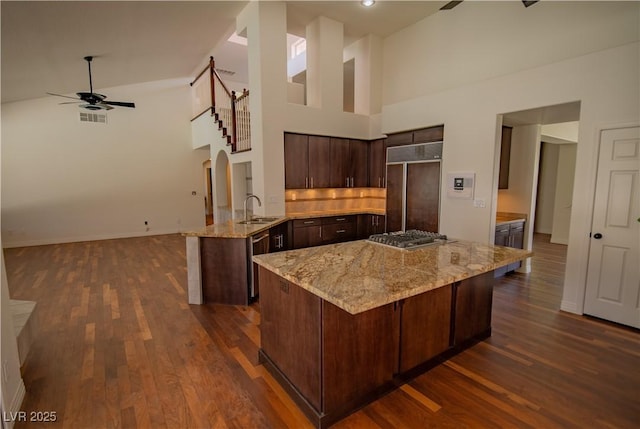 185 Camrose St, Henderson, NV 89074 - kitchen featuring stainless steel appliances, a sink, a towering ceiling, ceiling fan, and dark brown cabinetry