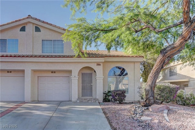 7968 Lisa Dawn Ave, Las Vegas, NV 89147 - mediterranean / spanish-style house with concrete driveway, stucco siding, a garage, and a tiled roof