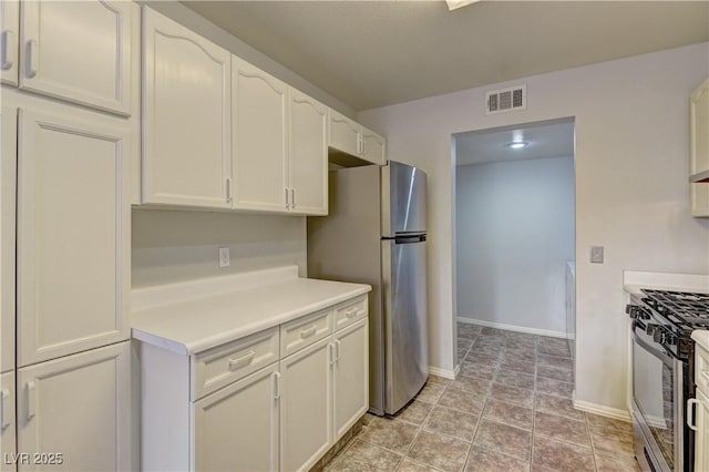 7968 Lisa Dawn Ave, Las Vegas, NV 89147 - kitchen featuring stainless steel appliances, baseboards, white cabinets, and light countertops