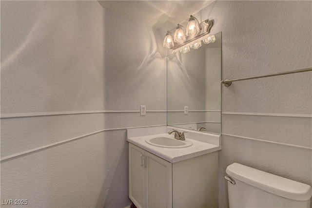 7968 Lisa Dawn Ave, Las Vegas, NV 89147 - half bath featuring vanity, toilet, and a textured wall