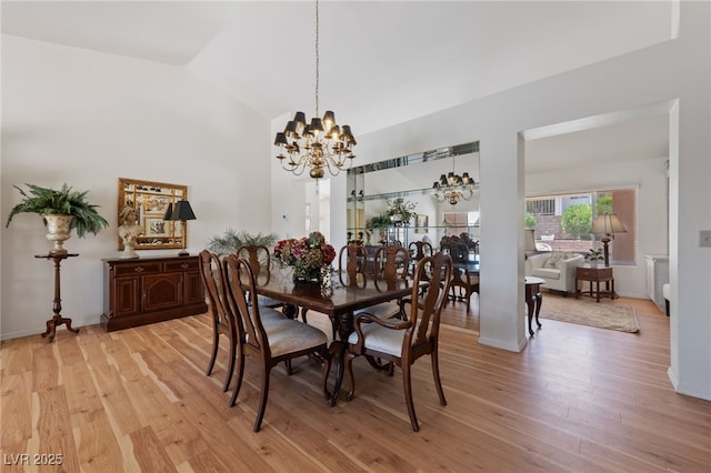 2925 Lotus Hill Dr, Las Vegas, NV 89134 - dining room with a chandelier, lofted ceiling, light wood-style floors, and baseboards