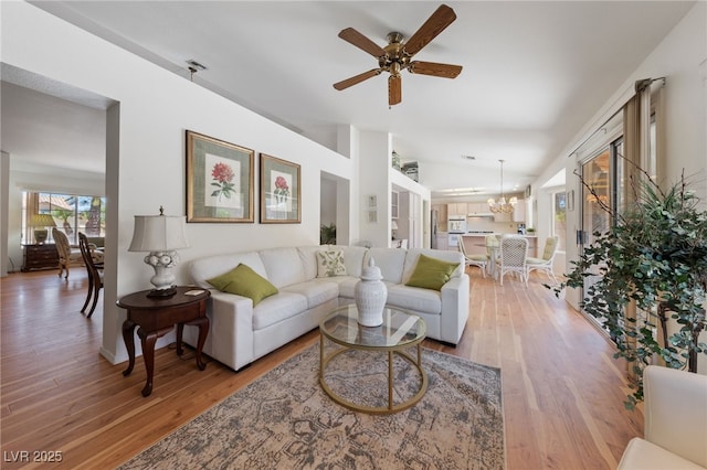 2925 Lotus Hill Dr, Las Vegas, NV 89134 - living room featuring lofted ceiling, ceiling fan, light wood finished floors, and a chandelier