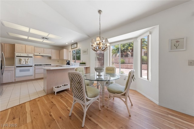 2925 Lotus Hill Dr, Las Vegas, NV 89134 - dining space with a chandelier, light wood finished floors, lofted ceiling, and baseboards