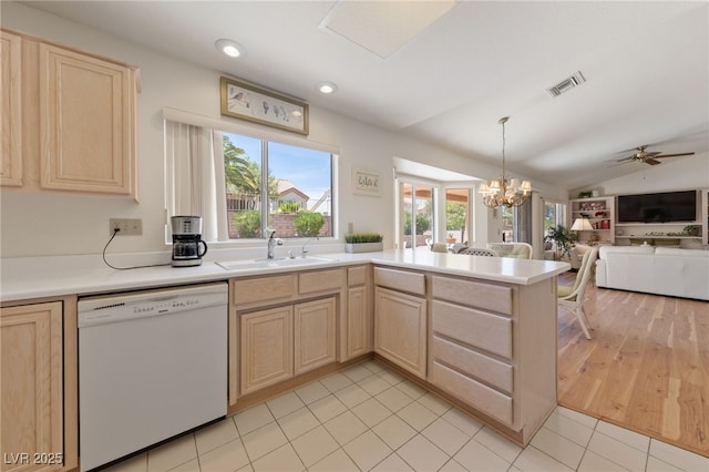 2925 Lotus Hill Dr, Las Vegas, NV 89134 - kitchen featuring white dishwasher, light brown cabinets, a sink, plenty of natural light, and vaulted ceiling