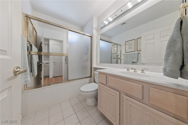 2925 Lotus Hill Dr, Las Vegas, NV 89134 - full bathroom featuring toilet, vanity, tile patterned flooring, and bath / shower combo with glass door