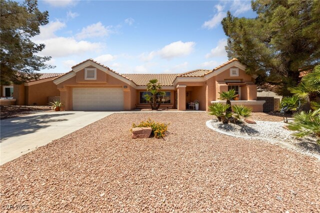 2925 Lotus Hill Dr, Las Vegas, NV 89134 - view of front facade featuring stucco siding, a garage, a tile roof, and driveway
