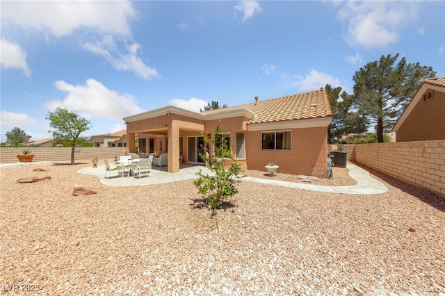 2925 Lotus Hill Dr, Las Vegas, NV 89134 - back of property with stucco siding, a tile roof, cooling unit, and a patio area