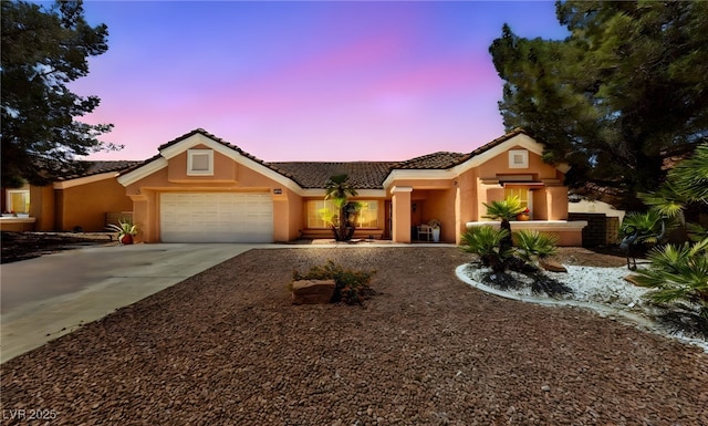 2925 Lotus Hill Dr, Las Vegas, NV 89134 - view of front of home with stucco siding, an attached garage, and a tile roof