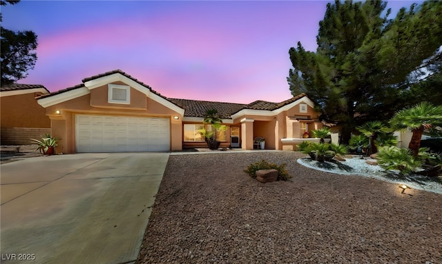 2925 Lotus Hill Dr, Las Vegas, NV 89134 - view of front of home with stucco siding, a tile roof, a garage, and driveway