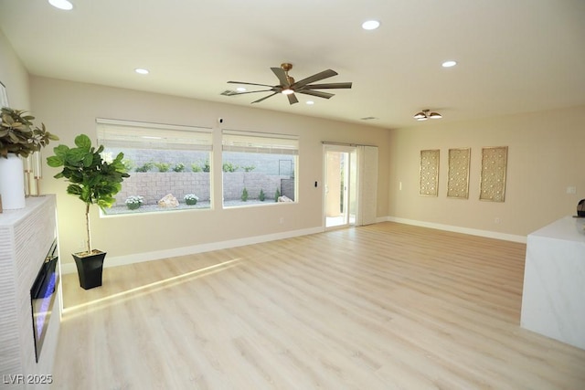 2623 Red Planet St, Henderson, NV 89044 - unfurnished living room featuring light wood-style flooring, a ceiling fan, recessed lighting, and baseboards