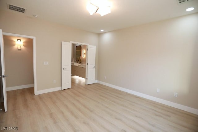 2623 Red Planet St, Henderson, NV 89044 - unfurnished bedroom with light wood-style flooring, a spacious closet, baseboards, recessed lighting, and connected bathroom