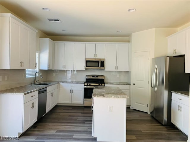 8793 Candelabra Ct, Las Vegas, NV 89148 - kitchen featuring appliances with stainless steel finishes, a sink, white cabinets, and recessed lighting