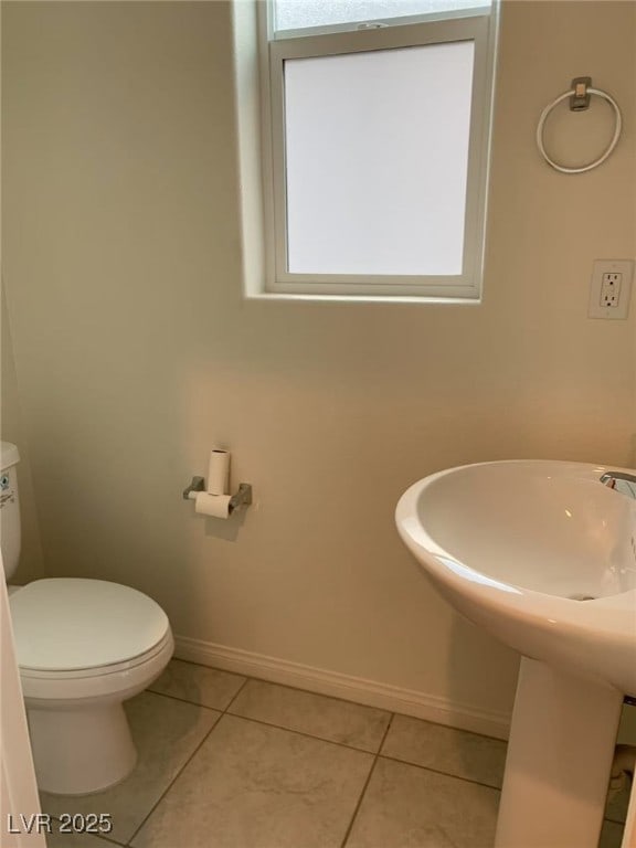 8793 Candelabra Ct, Las Vegas, NV 89148 - bathroom with tile patterned floors, baseboards, and toilet